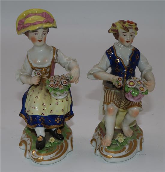 Pair of Derby porcelain figures in 18C costume holding flower baskets (faults)